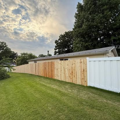 A new wood privacy fence running along a Metro East back yard, the kind of carpentry we build for Granite City homeowners